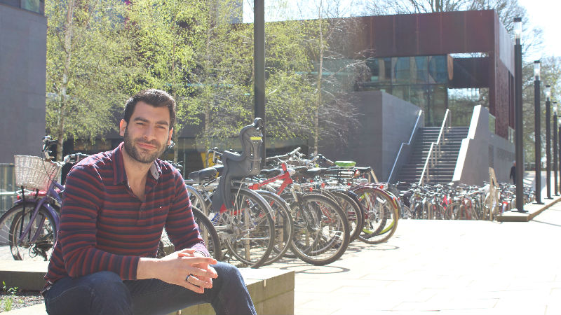 Student sat in front of bikes